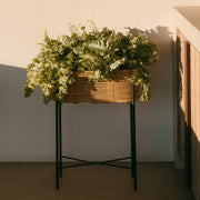 Beige and black rattan and metal floor planter
