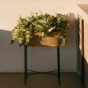 Beige and black rattan and metal floor planter