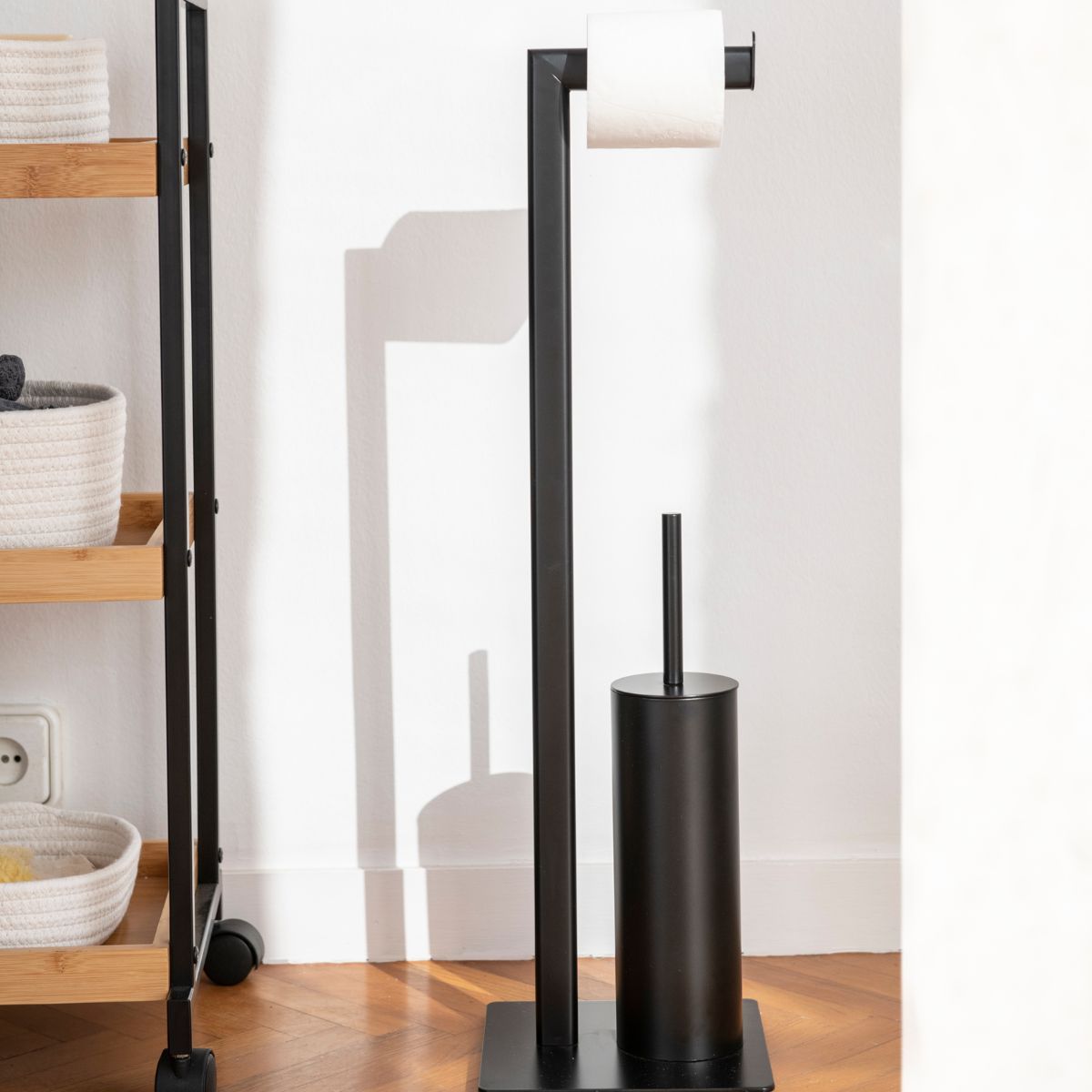 Matte black metal toilet roll holder with brush