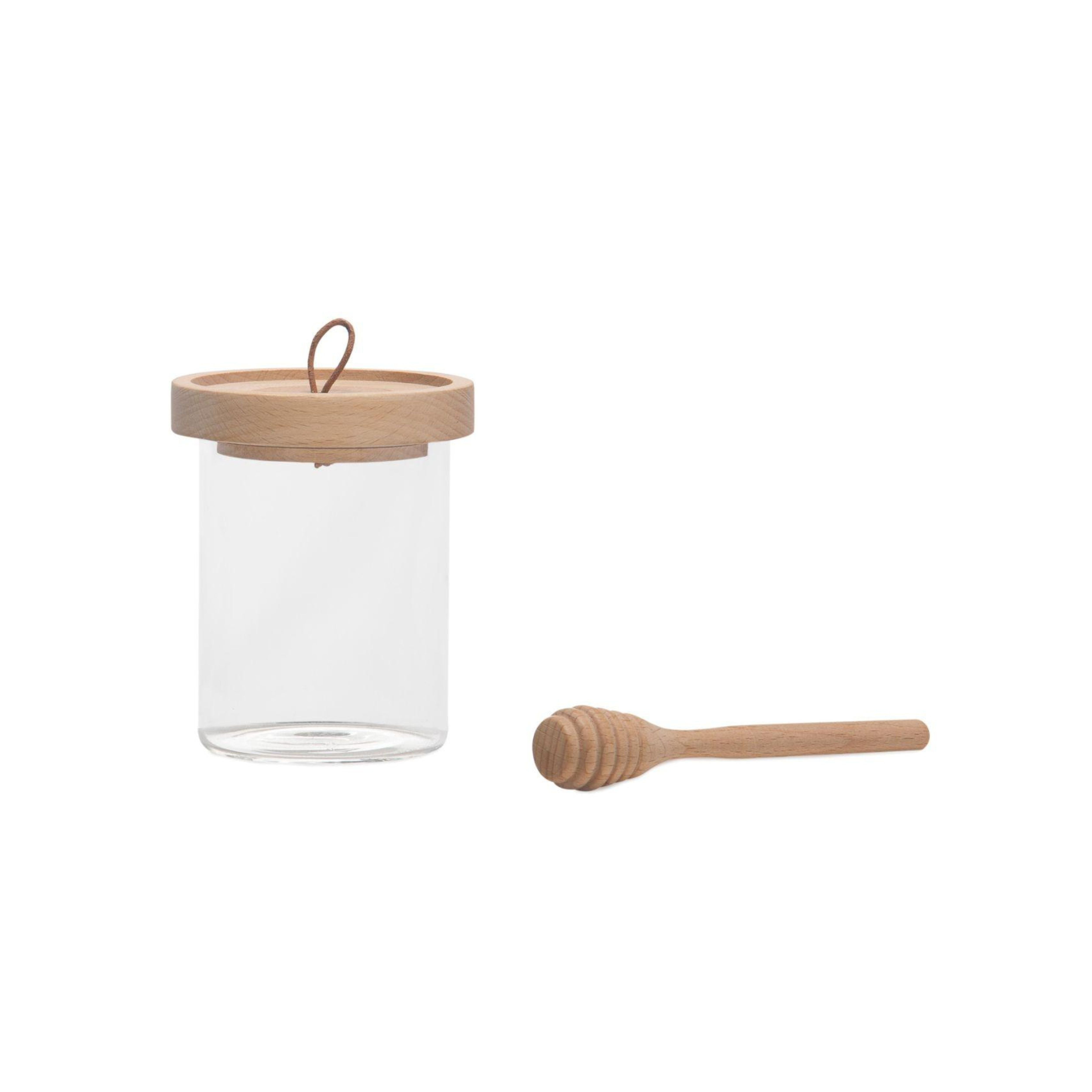 Tarro de miel de cristal con cuchara