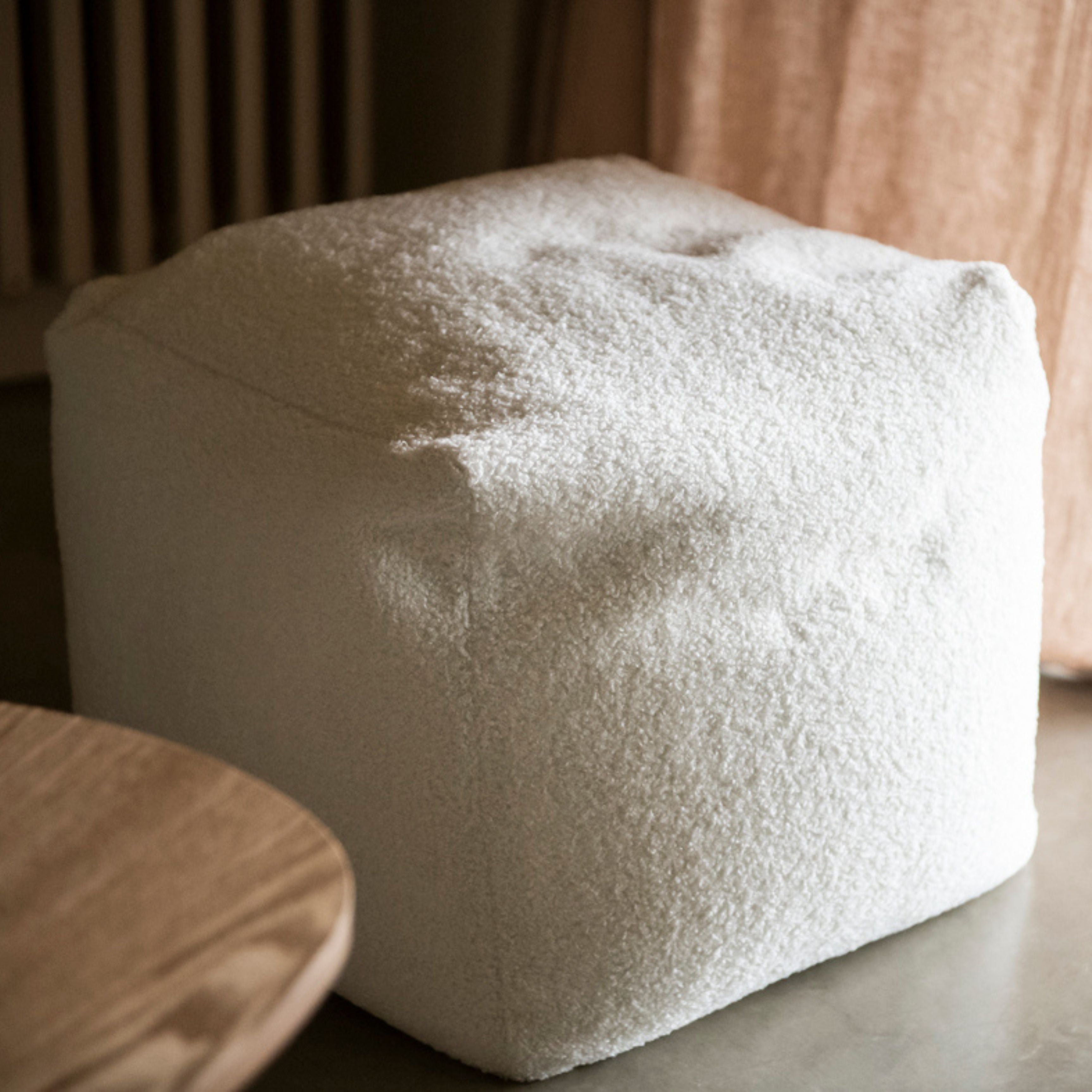 Square white upholstered pouf