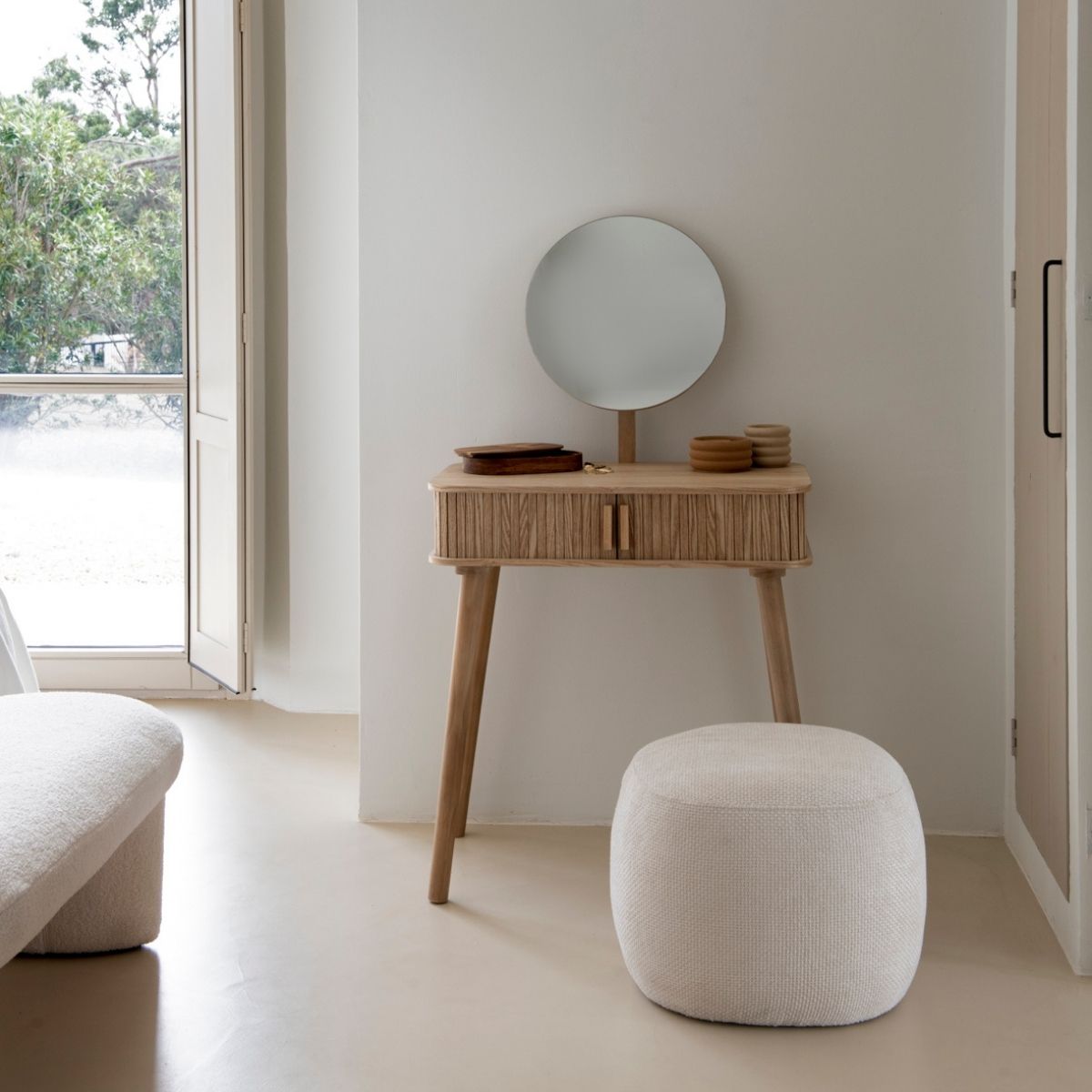 White upholstered round pouf